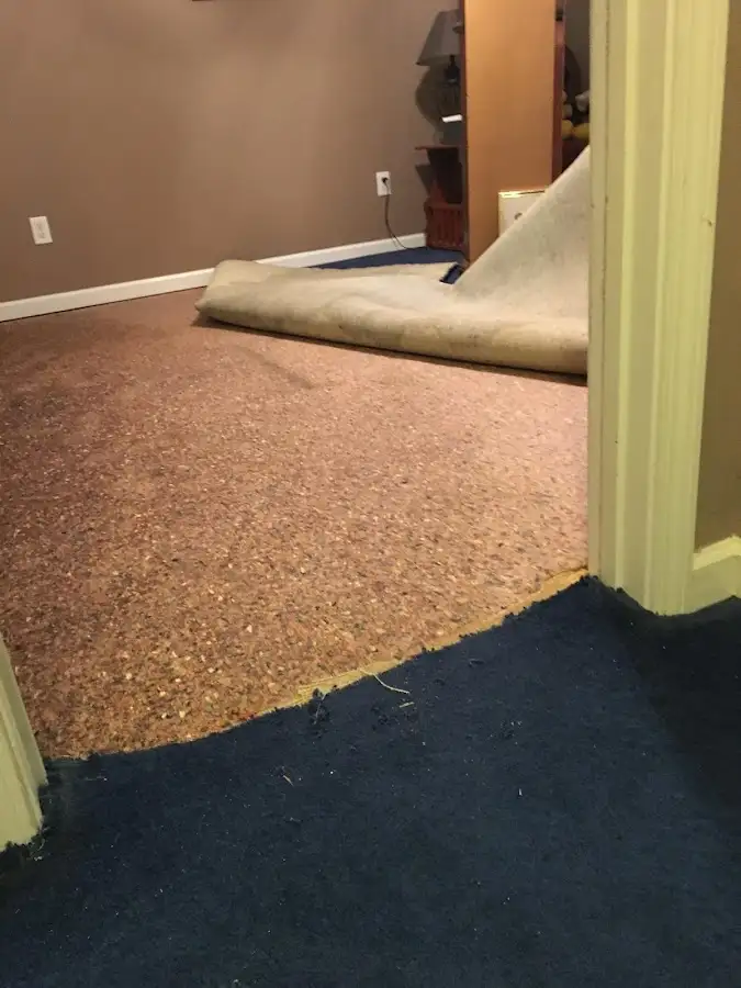 Carpet pad removal revealing water damage during Drying & Dehumidification in Jersey Village