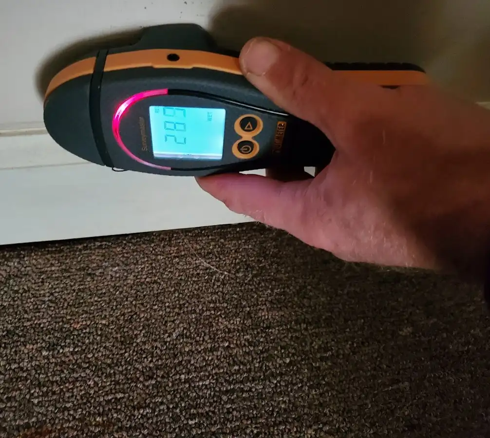 Moisture detection at baseboard during Storm Damage Restoration in Jersey Village